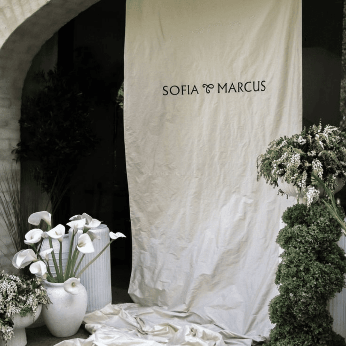 Welcome banner with calla lilies and greenery