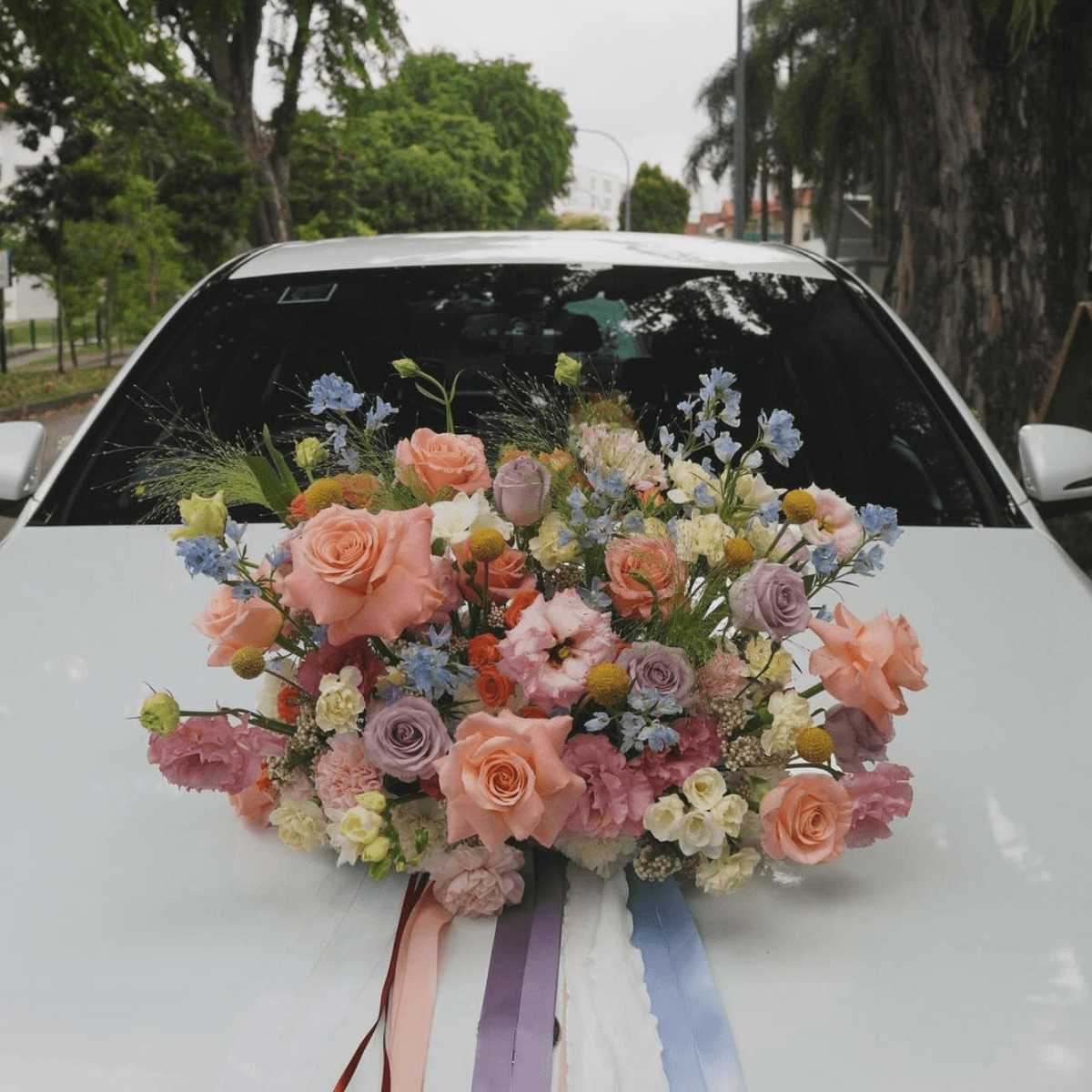 Premium colorful car bouquet on car hood